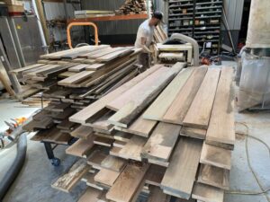 One of Chris's guys planes red oak on the 725 Woodmaster Molder/Planer. Chris has big plans to start manufacturing 1,000 - 1,500 sq. ft. modular cabins.