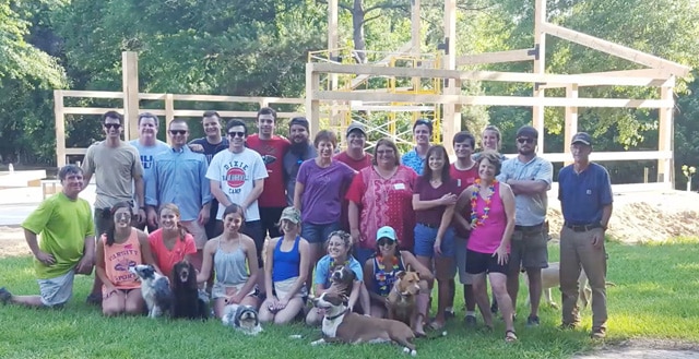 Part way through raising the barn, the Andries took a moment to snap a family photo. Then back to work!