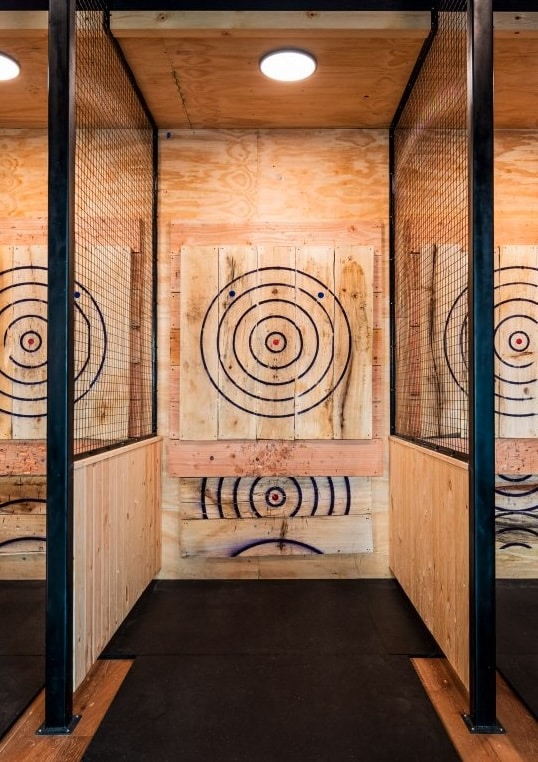 An axe-throwing lane featuring one of Aaron's wooden axe target boards he makes with his TimberKing Sawmill