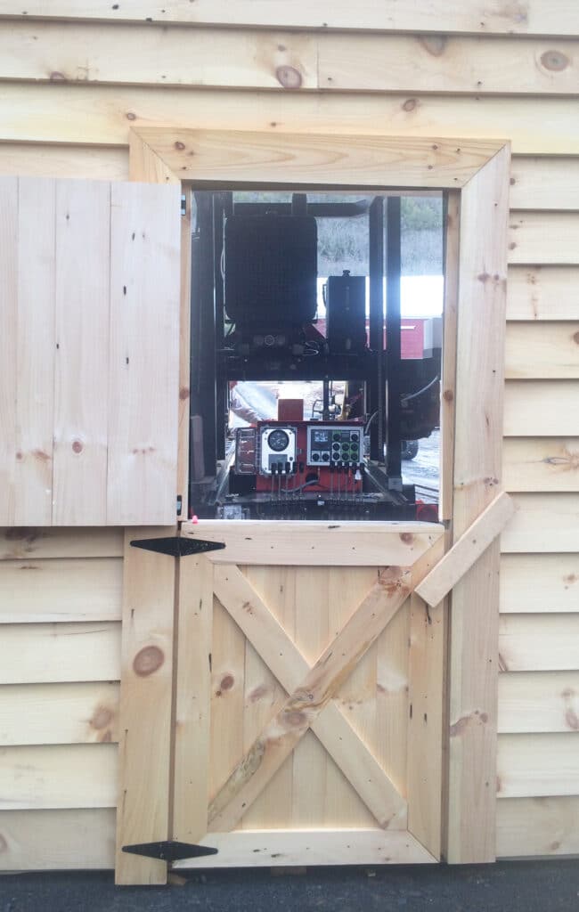 "I always keep my equipment under cover," John tells us. Then it's ready to go whenever he is. His new barn houses his TimberKing 2200.