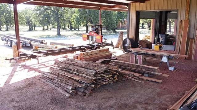 Open for business -- This is what a sawmill business looks like. A yard with a TimberKing mill, some raw materials, and sawn boards ready to go.