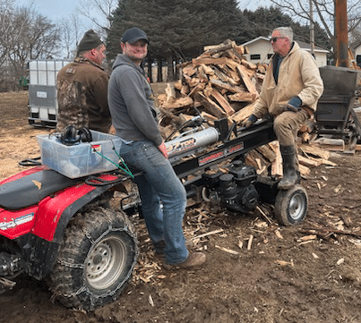 Friends splitting firewood