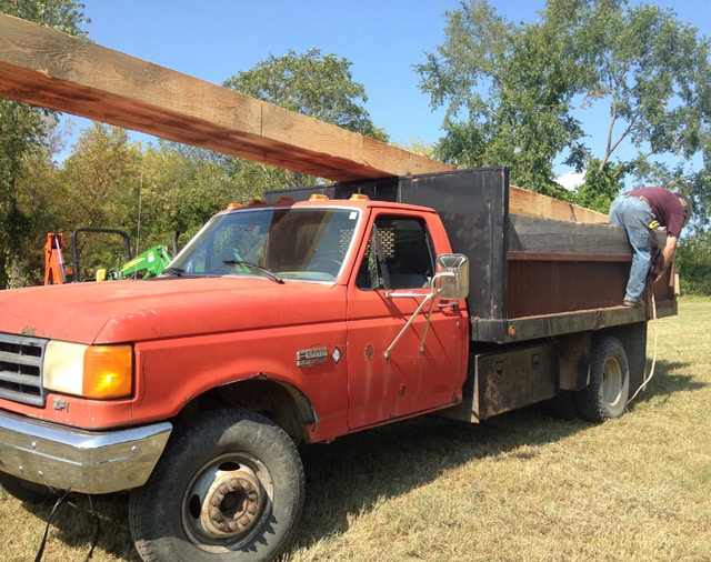 Here's Hank strapping down two 24' beams he sawed out with his TimberKing. The vehicle? "THE BEAST" is Hank's 1988 dump pickup.