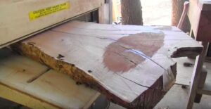 Doyle's got a Woodmaster Molder/Planer, too. Here he's using it to plane a slab of wood he sawed with his TimberKing.