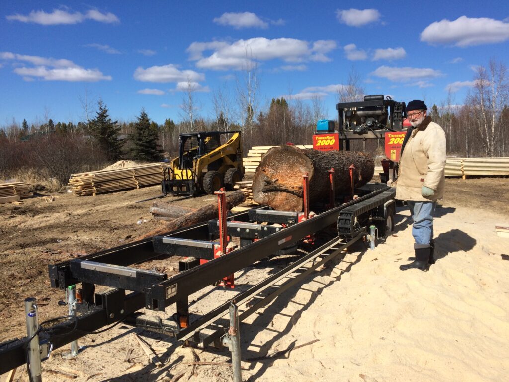 Daniel's dad, Severin Iseli, joins Daniel on the jobsite. Here's Severin alongside the mill and a 150-year old jack pine.