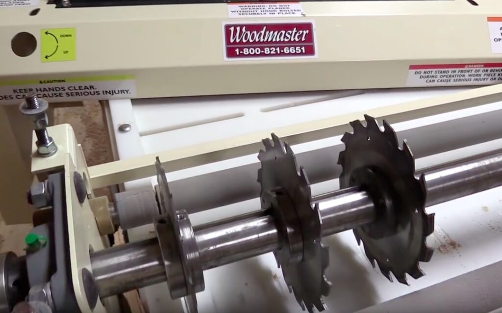The Woodmaster is a 4-in-1 money maker: planer, gang ripsaw, molder, drum sander. Here, it's set up as a gang ripsaw. It's the perfect "value-added" machine for TimberKing sawyers -- turn a $5 board into $75 worth of trim, flooring, more.