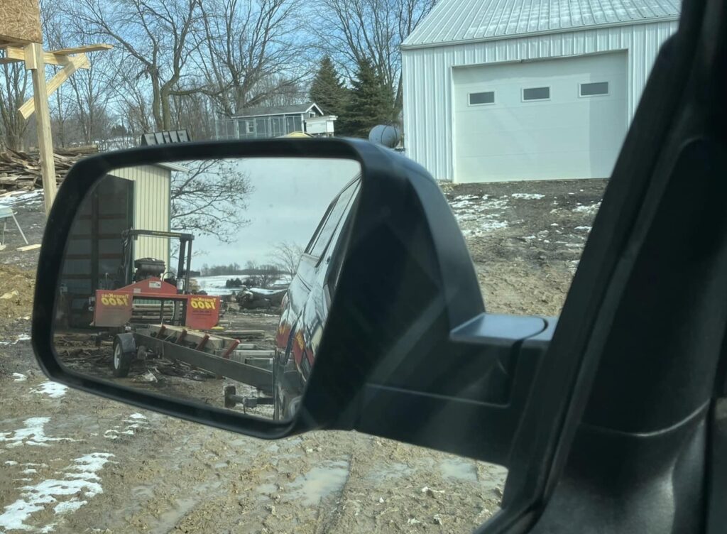 Norm snapped a quick picture of the view in his side mirror while backing up his TimberKing on a job site.