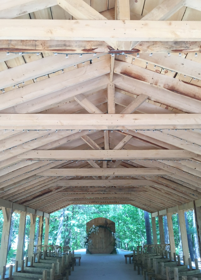 Outdoor wedding chapel truss roof and hemlock pews.