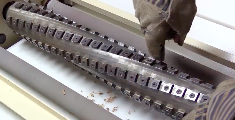 Bob sets up his Woodmaster as a gang ripsaw, then changes over to a planer function. Here he's installing the Woodmaster Spiral Cutterhead. "This cutterhead planes boards super smooth," he says.