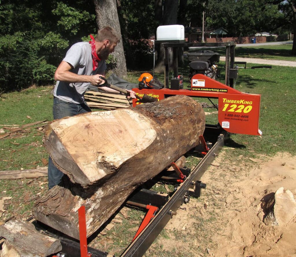Jim's son, Jonathan, builds furniture from lumber his dad saws. Here's Jonathan stripping bark off a 27" diameter maple.